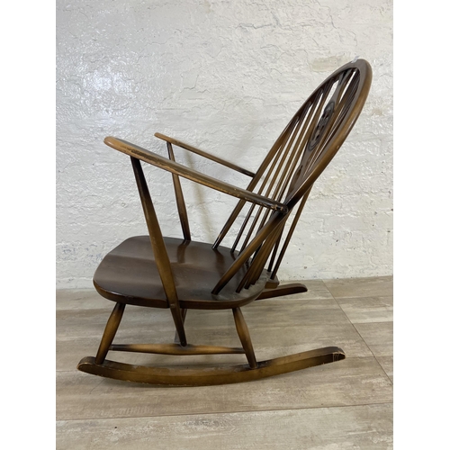 122 - A mid 20th century Ercol Fleur De Lys elm and beech rocking chair