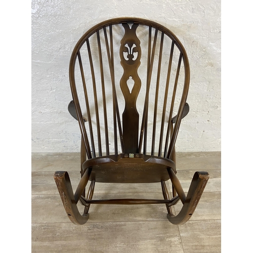 122 - A mid 20th century Ercol Fleur De Lys elm and beech rocking chair