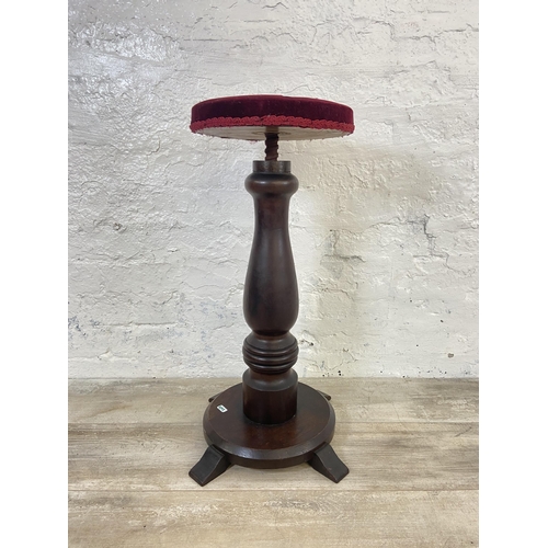 123 - A Victorian rosewood height adjustable revolving piano stool with red fabric upholstered seat - appr... 