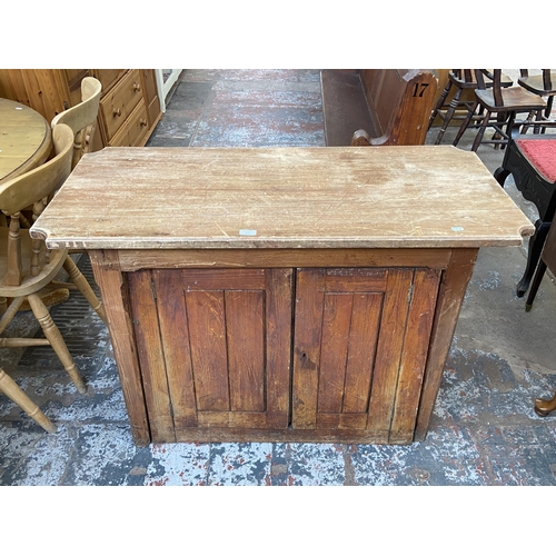 126 - A Victorian pitch pine two door cabinet - approx. 82cm high x 116cm wide x 53cm deep