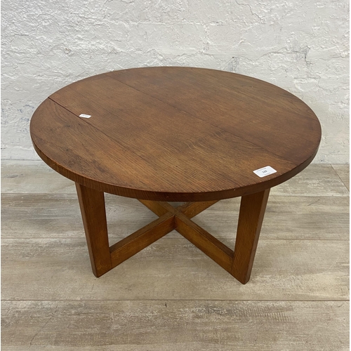 129 - A mid 20th century oak circular coffee table - approx. 38cm high x 66cm diameter