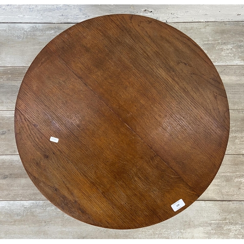 129 - A mid 20th century oak circular coffee table - approx. 38cm high x 66cm diameter