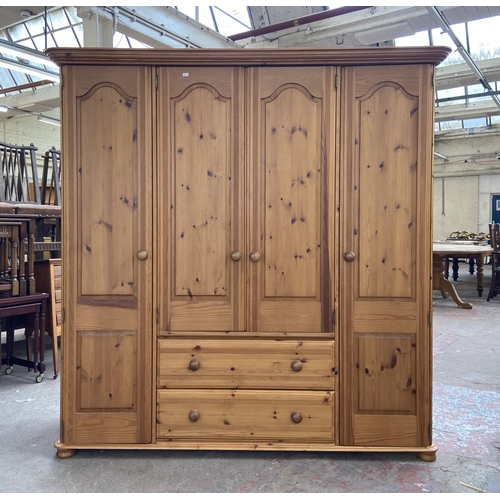 134 - A modern pine four door wardrobe - approx. 183cm high x 180cm wide x 62cm deep