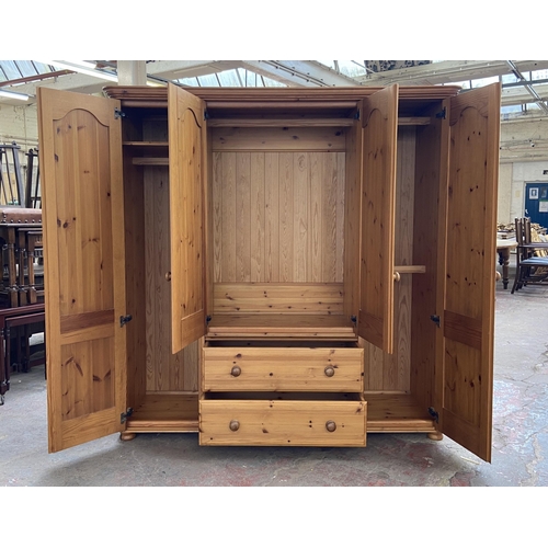 134 - A modern pine four door wardrobe - approx. 183cm high x 180cm wide x 62cm deep