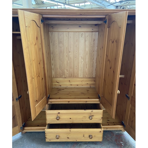 134 - A modern pine four door wardrobe - approx. 183cm high x 180cm wide x 62cm deep