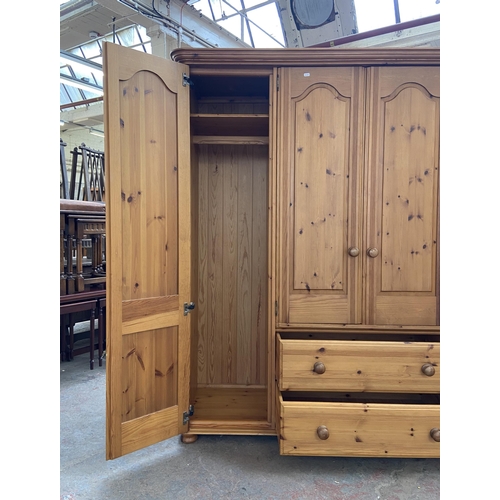 134 - A modern pine four door wardrobe - approx. 183cm high x 180cm wide x 62cm deep