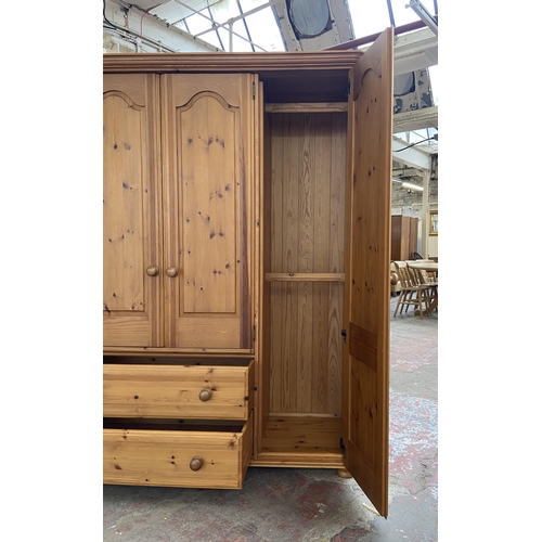 134 - A modern pine four door wardrobe - approx. 183cm high x 180cm wide x 62cm deep