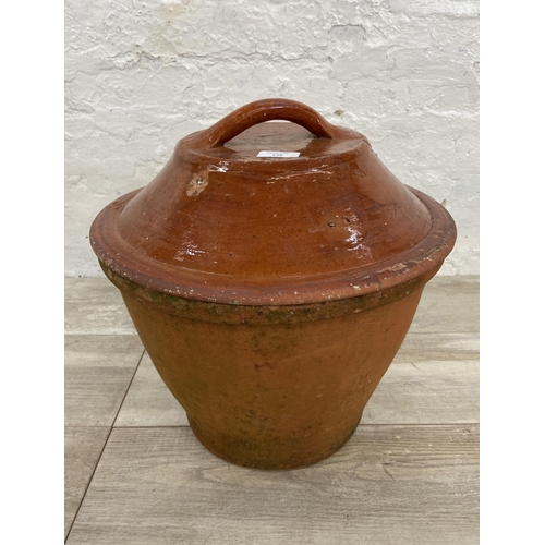 138 - A terracotta pot with Victorian glazed terracotta lid - approx. 40cm high