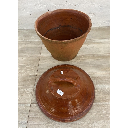 138 - A terracotta pot with Victorian glazed terracotta lid - approx. 40cm high