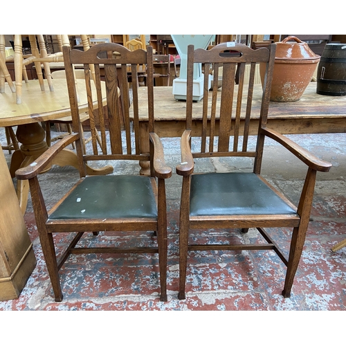 146 - A pair of Arts and Crafts oak and green vinyl upholstered carver dining chairs