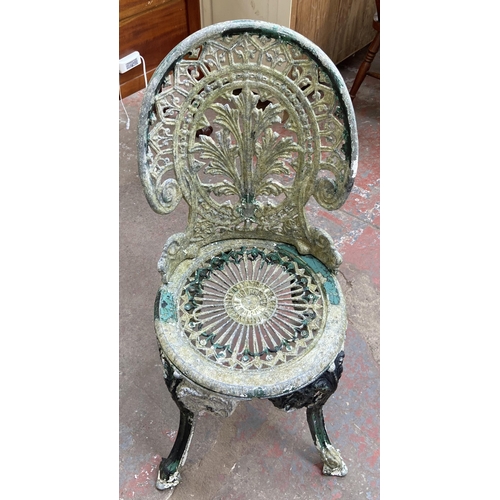 153 - A Victorian style cast metal three piece patio set comprising circular table and two chairs - table ... 