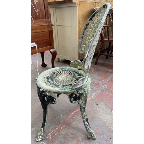 153 - A Victorian style cast metal three piece patio set comprising circular table and two chairs - table ... 