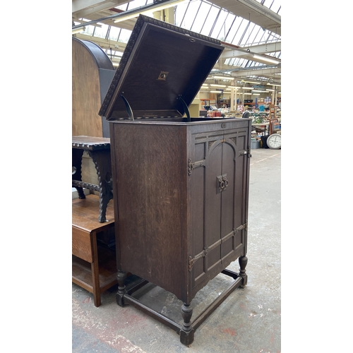 155 - A 1930s His Master's Voice carved oak gramophone cabinet - approx. 126cm high x 73cm wide x 60cm dee... 