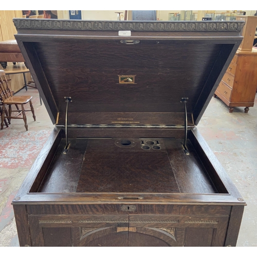 155 - A 1930s His Master's Voice carved oak gramophone cabinet - approx. 126cm high x 73cm wide x 60cm dee... 