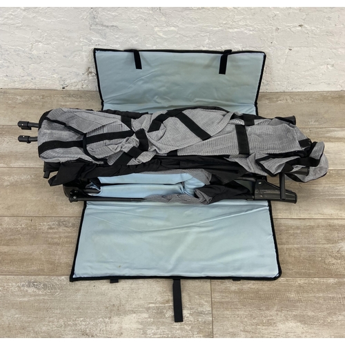 162 - A folding baby travel cot