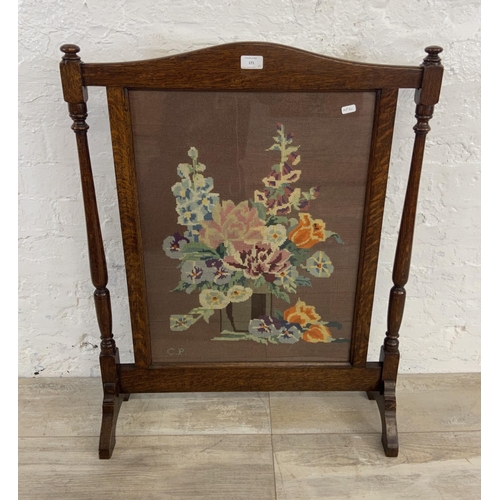 171 - Two early 20th century fire screens, one mahogany and fabric shield shaped and one oak and tapestry ... 