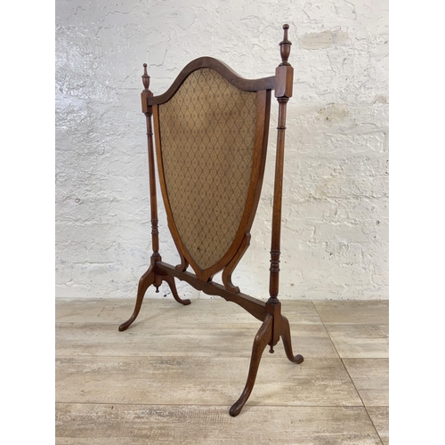 171 - Two early 20th century fire screens, one mahogany and fabric shield shaped and one oak and tapestry ... 