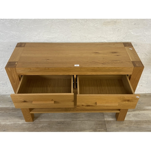 176 - A modern oak two drawer console table - approx. 70cm high x 110cm wide x 38 deep