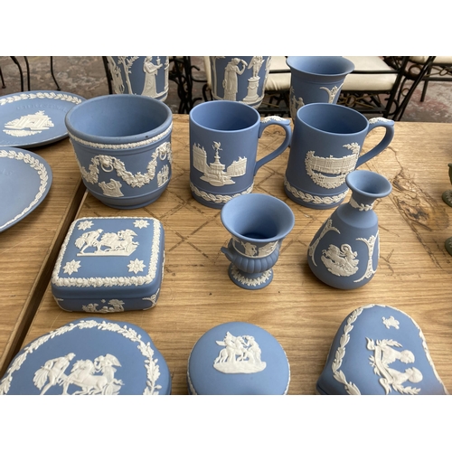 365 - Seventeen pieces of Wedgwood pale blue Jasperware to include two cups and saucers, five trinket boxe... 