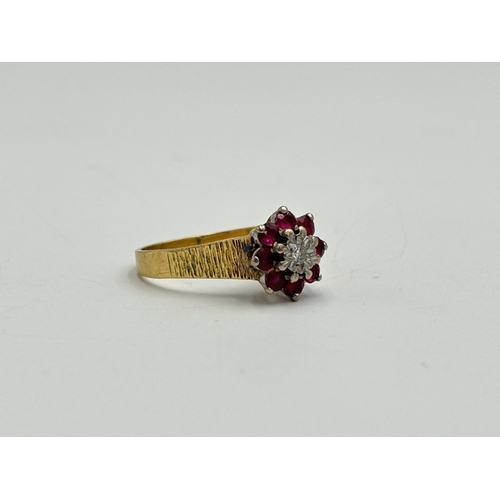 2209A - A hallmarked London 18ct gold ruby and diamond floral cluster ring with textured shoulders, size Q -... 