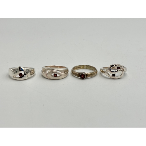 2251 - Four .925 silver garnet set dress rings - approx. gross weight 15.7g