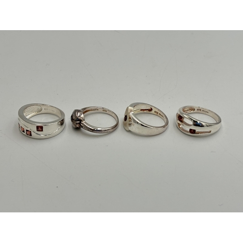 2255 - Four .925 silver garnet set dress rings - approx. gross weight 16.6g