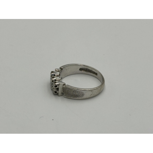 2259V - A mid 20th century hallmarked Birmingham 18ct white gold diamond six stone ring with textured should... 