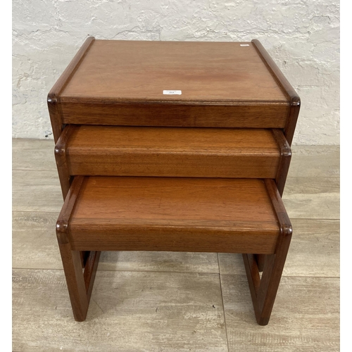 50 - A mid 20th century teak nest of three tables