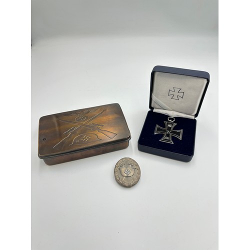 2391 - Three German military items, one WWII silver wound badge, one reproduction rectangular tin and one b... 