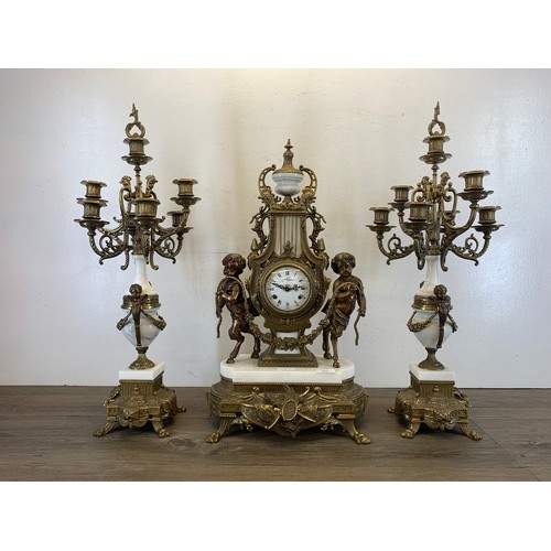 2 - A 20th century Italian Brevettato brass and white marble mantel clock and garniture set with cherub ... 