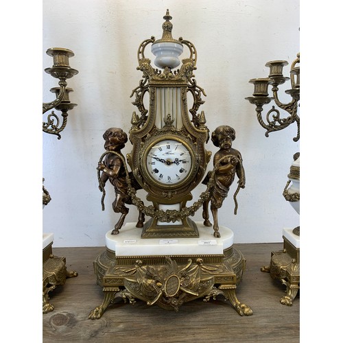 2 - A 20th century Italian Brevettato brass and white marble mantel clock and garniture set with cherub ... 