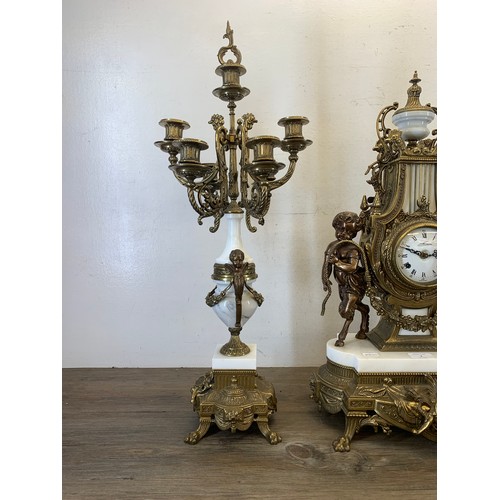 2 - A 20th century Italian Brevettato brass and white marble mantel clock and garniture set with cherub ... 