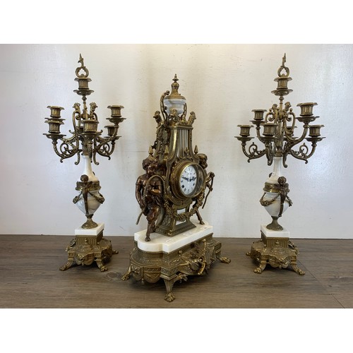 2 - A 20th century Italian Brevettato brass and white marble mantel clock and garniture set with cherub ... 