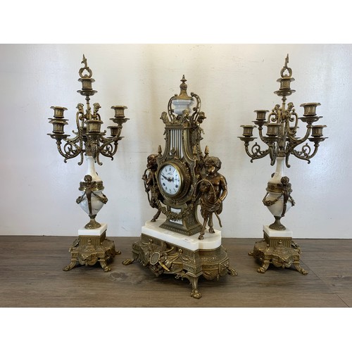 2 - A 20th century Italian Brevettato brass and white marble mantel clock and garniture set with cherub ... 