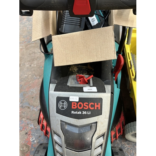 1039 - A collection of items to include Bosch Rotak 36 LI cordless lawnmower with battery and charger, Bosc... 