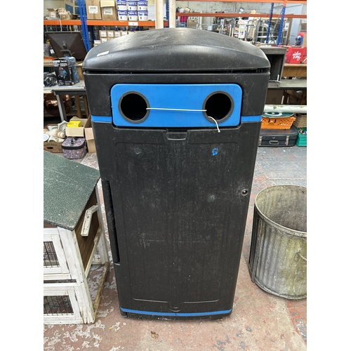 1041 - A black plastic bottle bin - approx. 140cm high x 70cm square