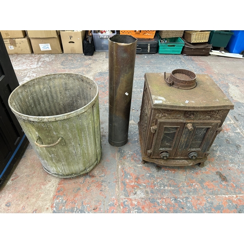 1042 - Two items, one cast iron stove and one galvanized bin