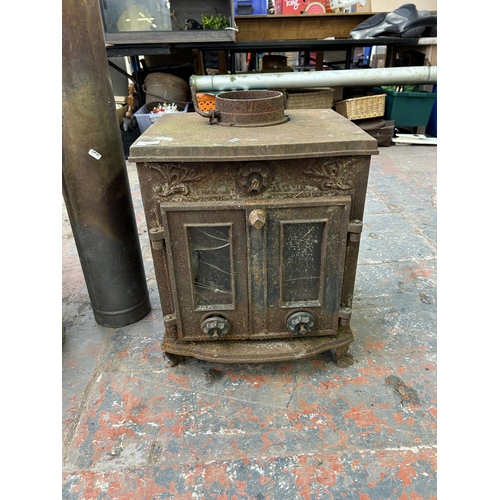 1042 - Two items, one cast iron stove and one galvanized bin