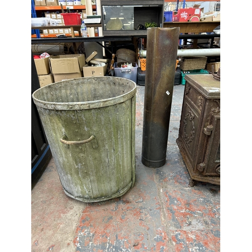 1042 - Two items, one cast iron stove and one galvanized bin