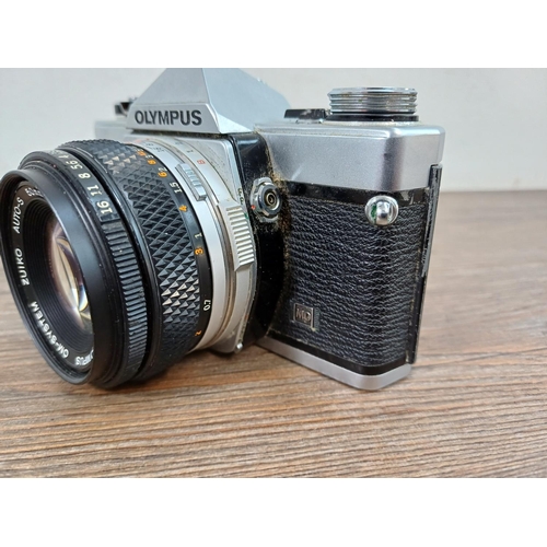 743 - A cased Olympus OM-2N 35mm SLR camera fitted with Zuiko 1:1.8 f=50mm Auto-s lens