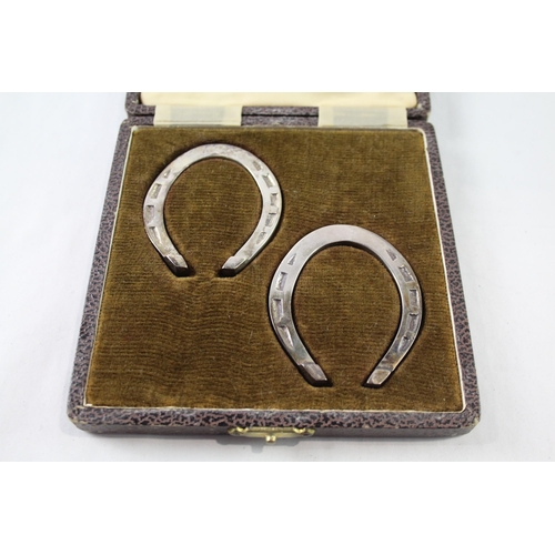 2378 - A boxed set of two hallmarked sterling silver lucky horse shoe serviette rings - approx. gross weigh... 