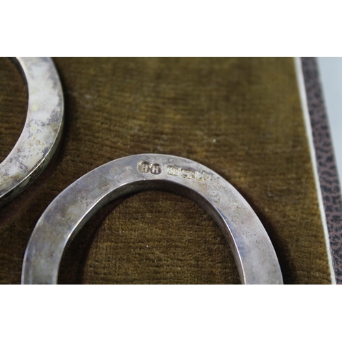 2378 - A boxed set of two hallmarked sterling silver lucky horse shoe serviette rings - approx. gross weigh... 