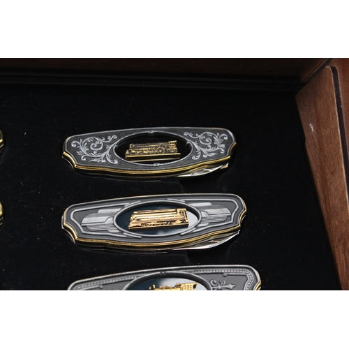 562 - A Franklin Mint Railroad collector's folding knife set