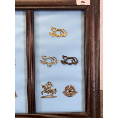 2429 - Seventeen framed Yeomanry military cap badges