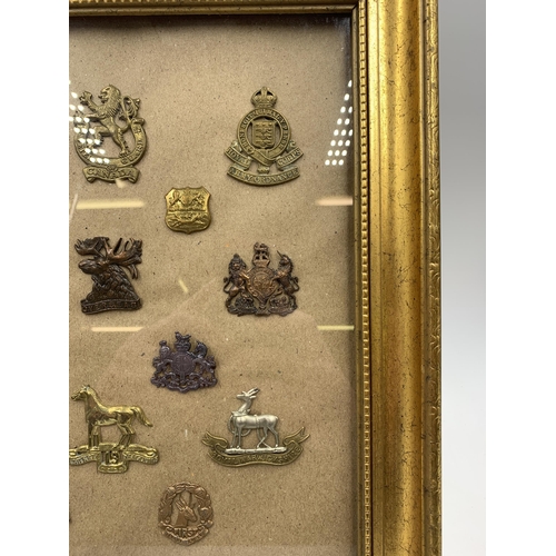 2430 - Fifteen framed military cap badges