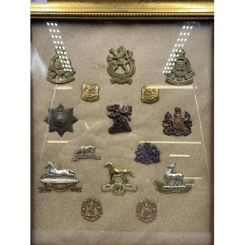 2430 - Fifteen framed military cap badges