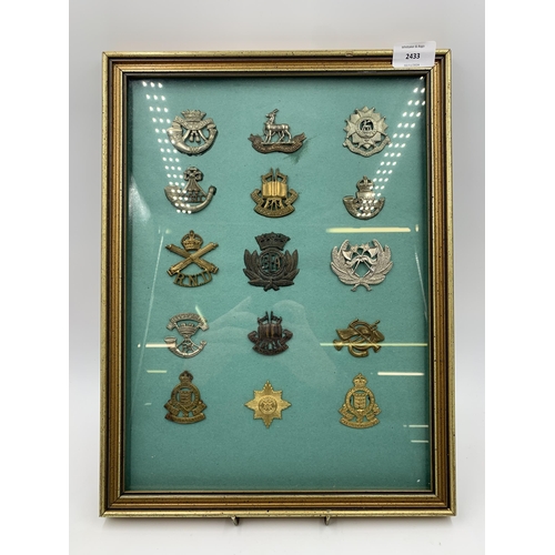 2433 - Fifteen framed military cap badges