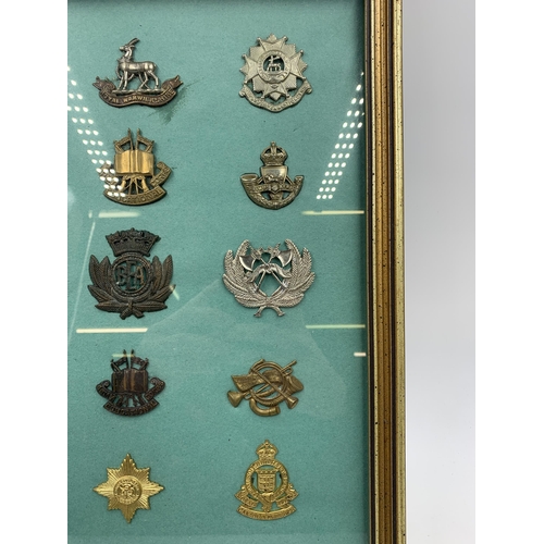 2433 - Fifteen framed military cap badges