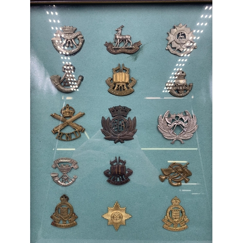 2433 - Fifteen framed military cap badges