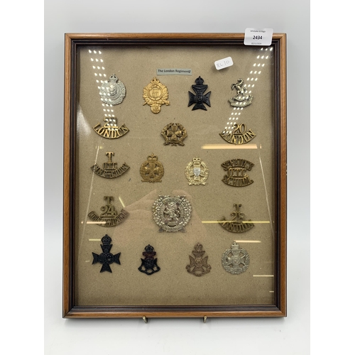 2434 - Eighteen framed London Regiments military cap badges